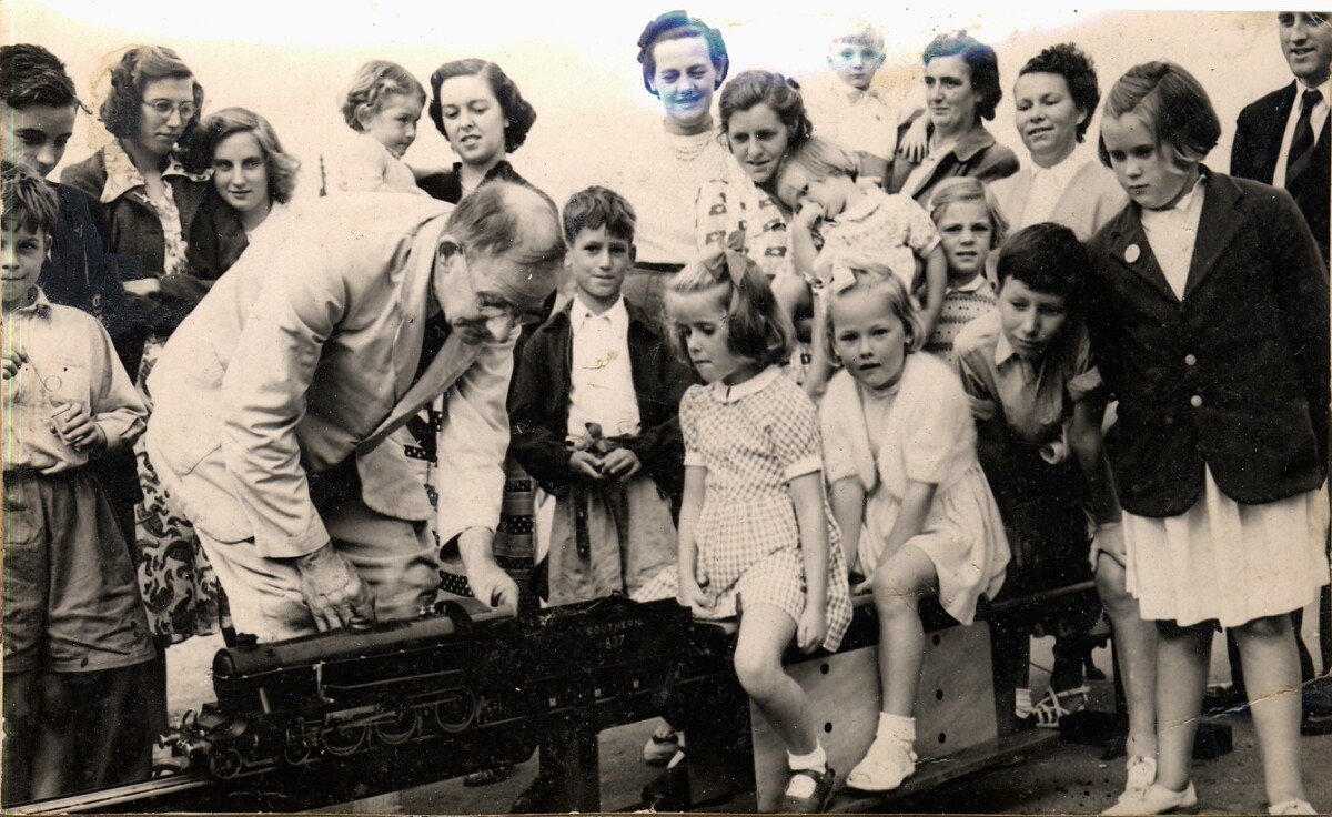 19520800 GUY S. LONG with one of his locomotives at Fête near Broadstone, Dorset